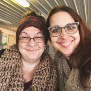 two woman in hand knit and crocheted goodness saying goodbye at Miller Ferry